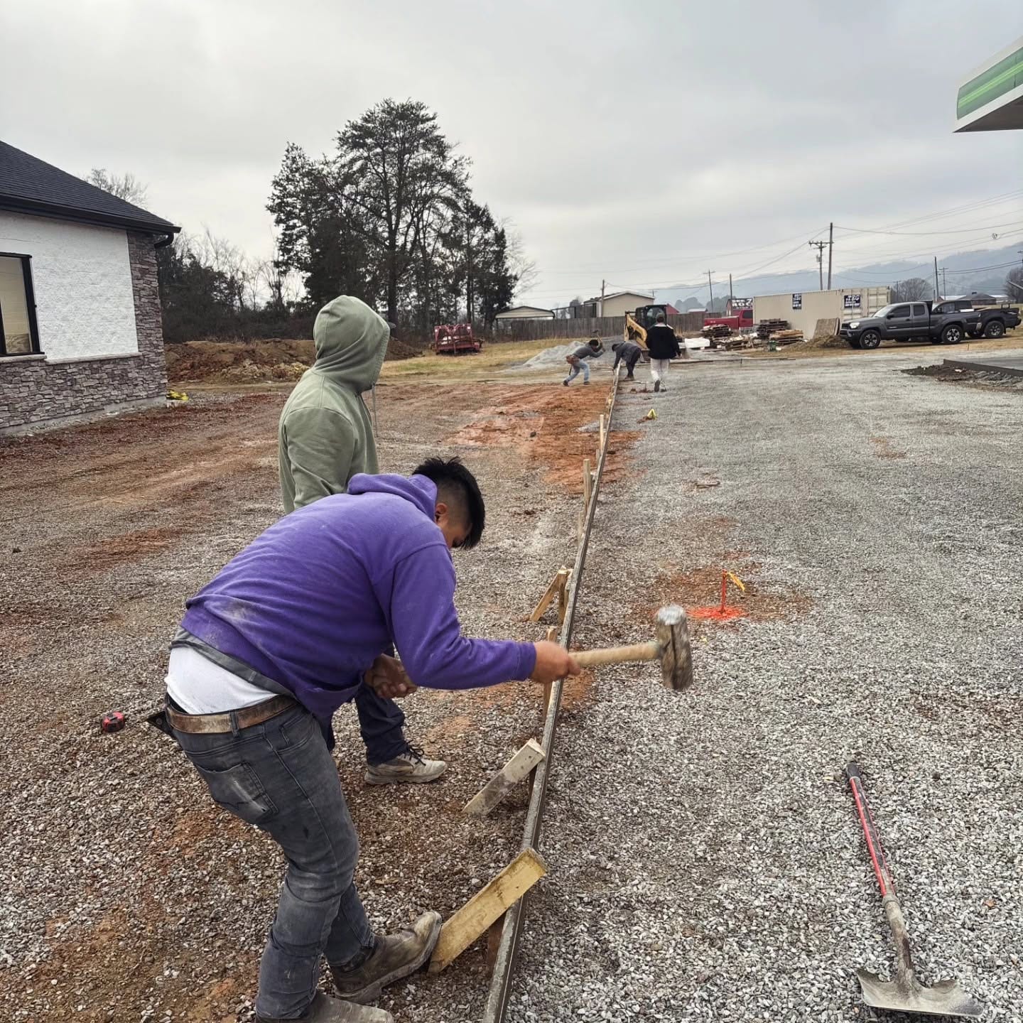 Crew setting forms and gravel base for a concrete pour